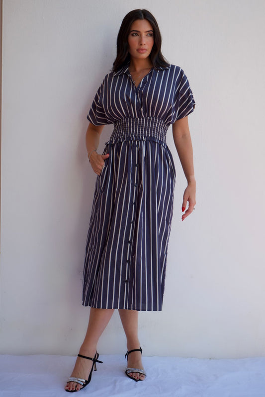 Navy stripe button-front midi dress with smocked waist for elegant everyday wear.