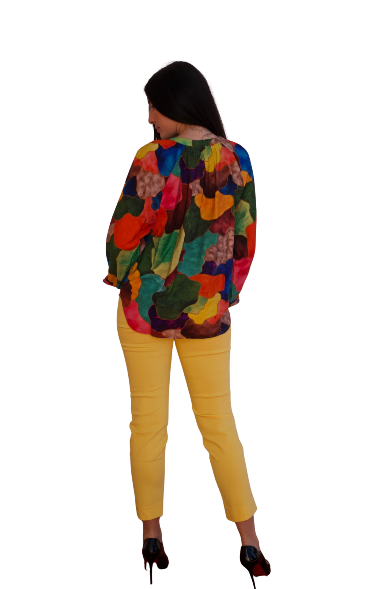 Model wearing a colorful crinkle blouse with painterly abstract print in vibrant tones.