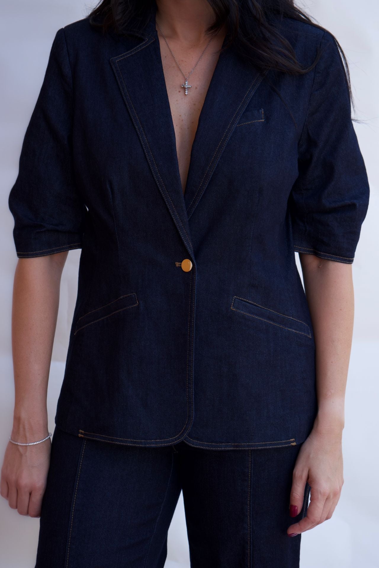 Dark denim tailored blazer with contrast stitching and single button closure available online and in-store