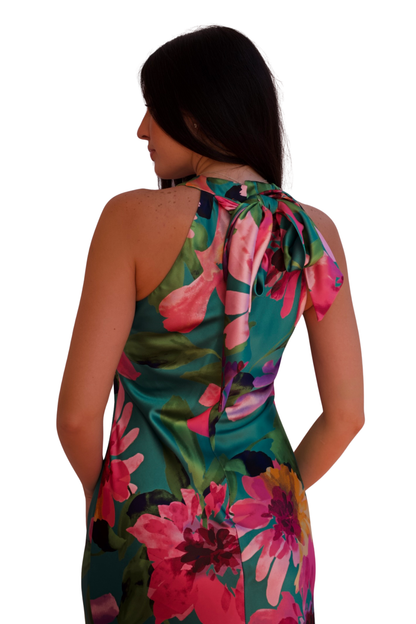 Elegant emerald green satin halter evening gown with vibrant floral print, sleeveless design and fitted silhouette, ideal for formal events and wedding guests.