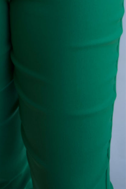 Emerald green tailored pull on pants with front pockets and silver buttons closeup.