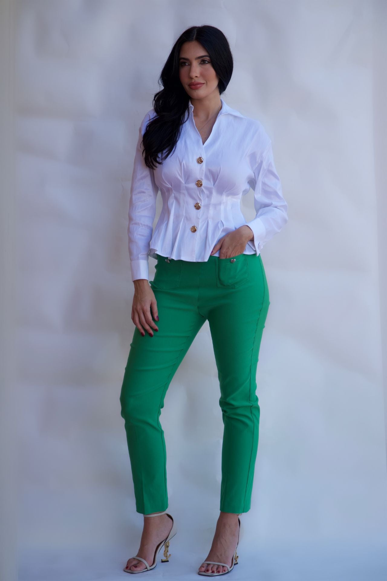 Emerald green tailored pull on pants with front pockets and silver buttons styled with white blouse available online and in-store