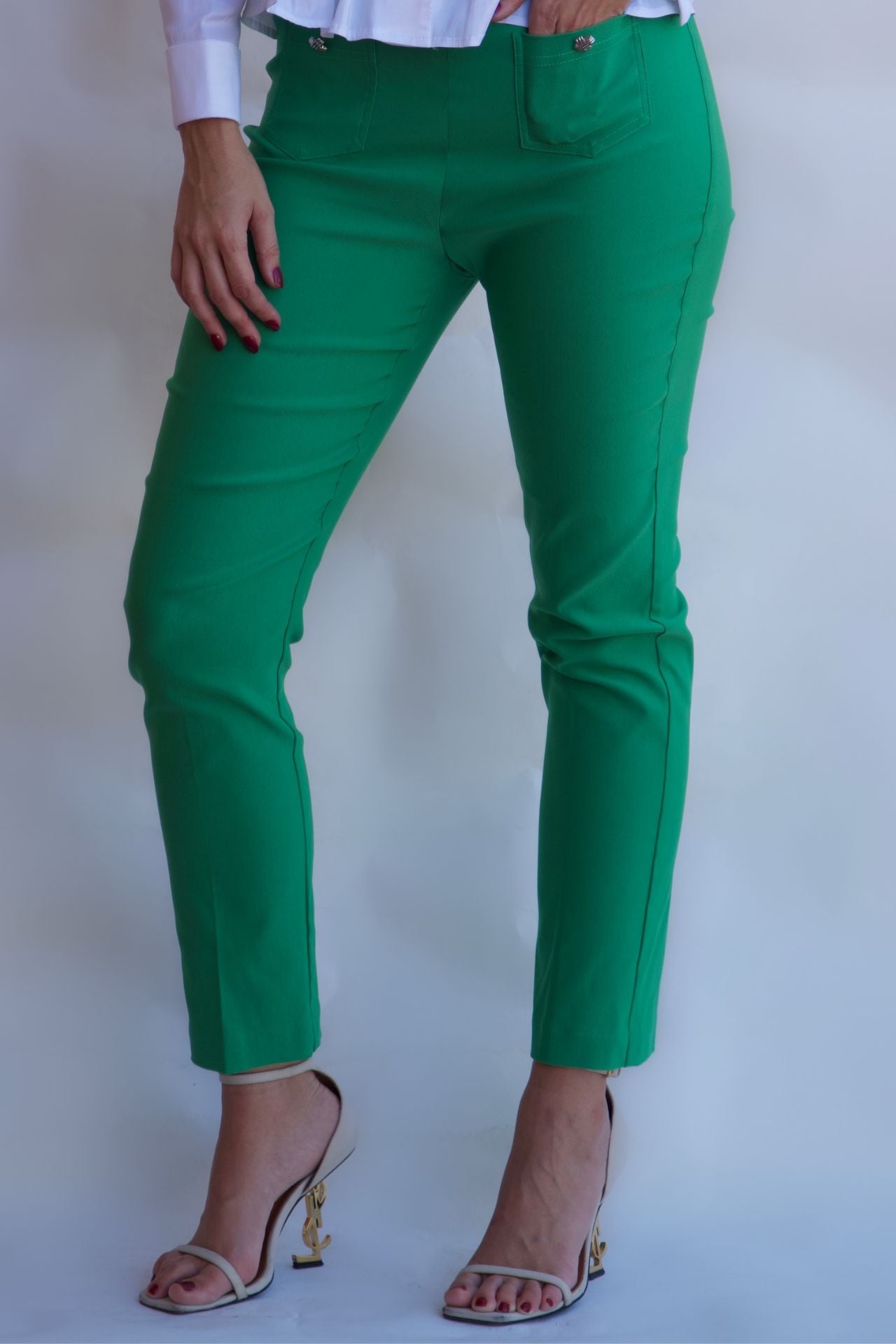 Emerald green tailored pull on pants with front pockets and silver buttons styled with white blouse available online and in-store