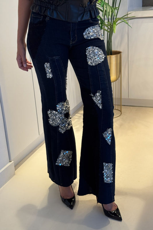 Dark wash wide-leg denim with floral sequin appliqué patches and high-rise fit.