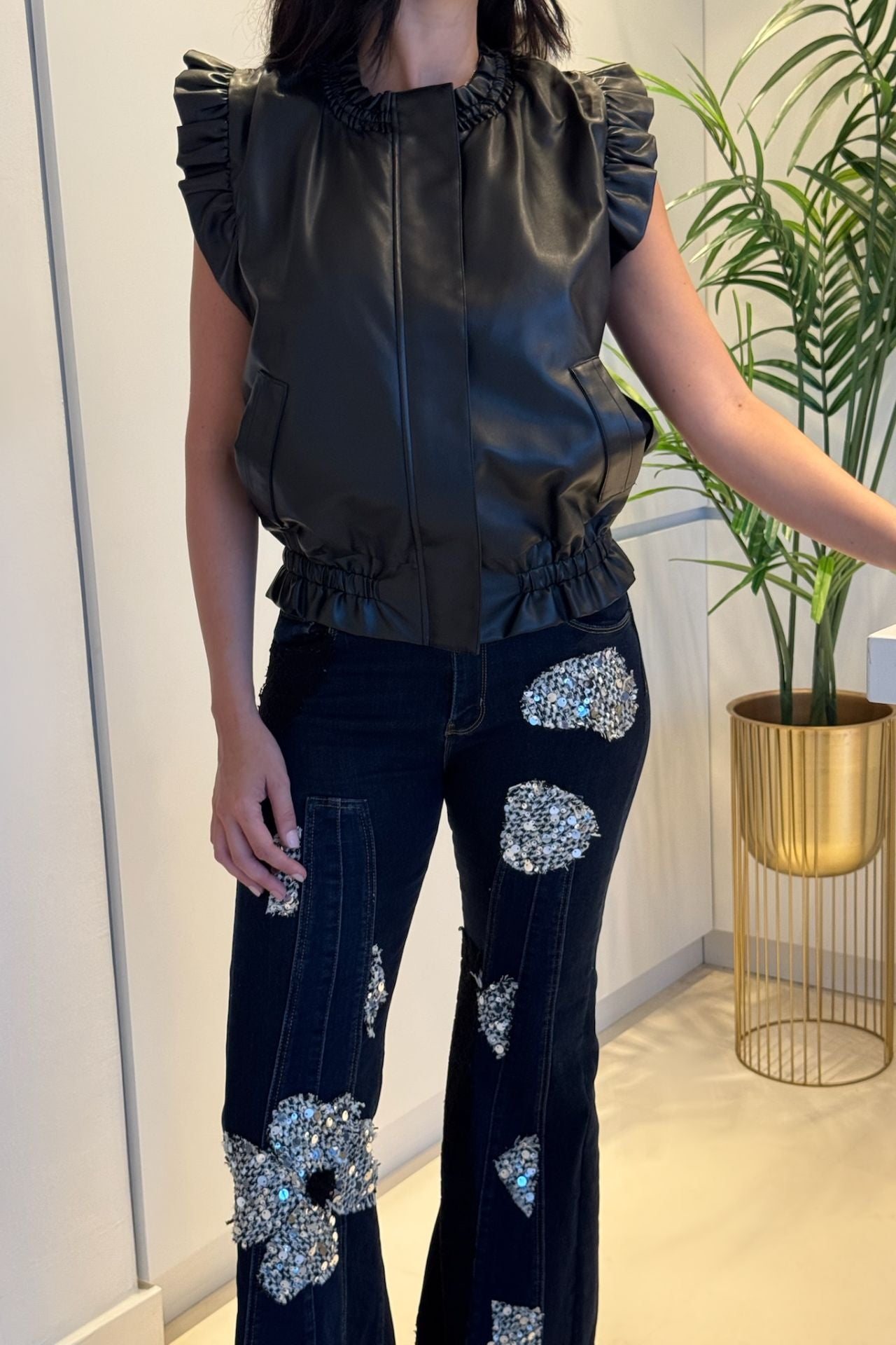 Dark wash wide-leg denim with floral sequin appliqué patches and high-rise fit.