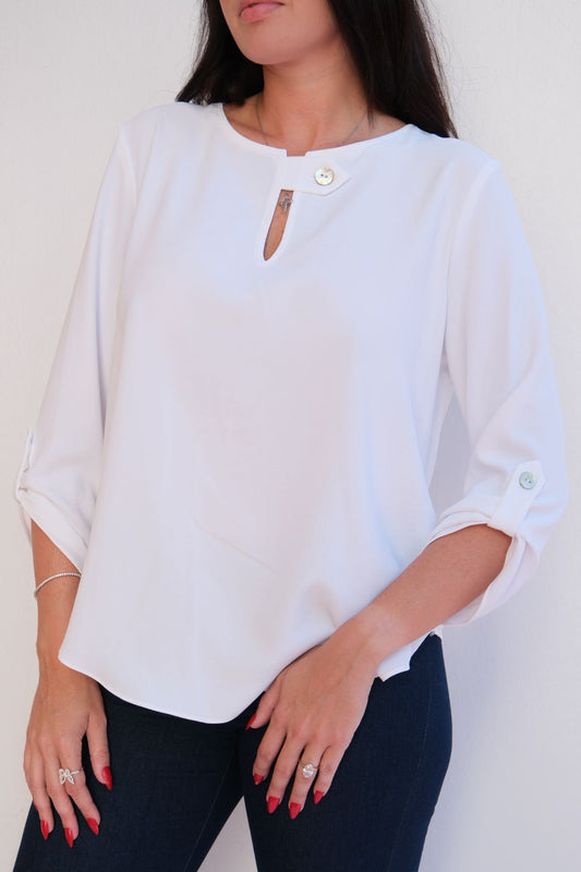 white flow blouse with jewel button neckline detail and relaxed fit styled with dark denim