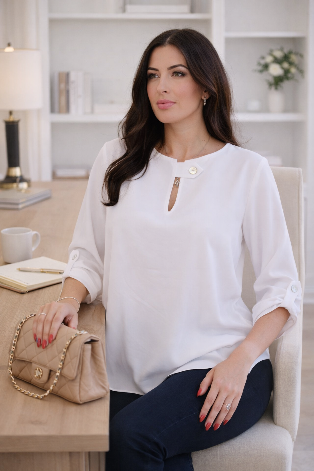 white flow blouse with jewel button neckline detail and relaxed fit styled with dark denim