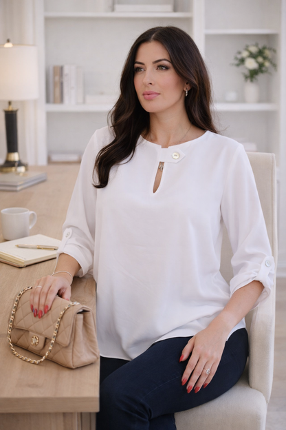 white flow blouse with jewel button neckline detail and relaxed fit styled with dark denim