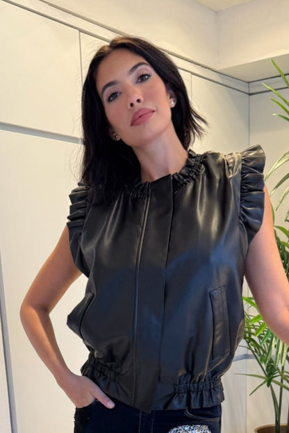 Black pleather vest with ruffle-trim shoulders and an elasticized hem.