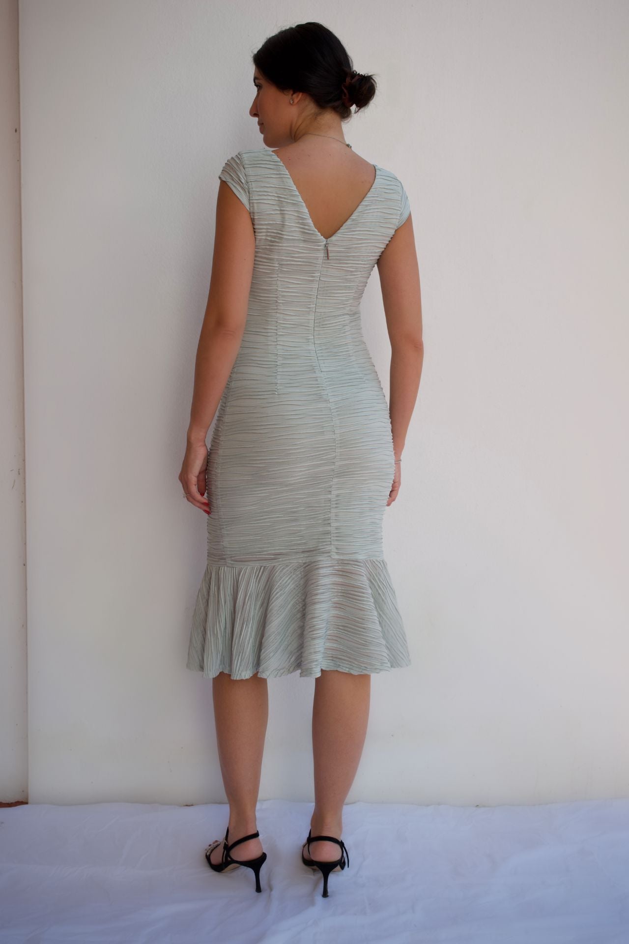 Mint wave-texture midi cocktail dress with ruffle hem and elegant neckline detail back view.