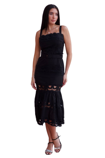 Woman wearing a lace detail belted maxi dress with ruffle hem in black and white.