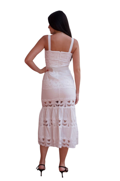 Woman wearing a lace detail belted maxi dress with ruffle hem in black and white.