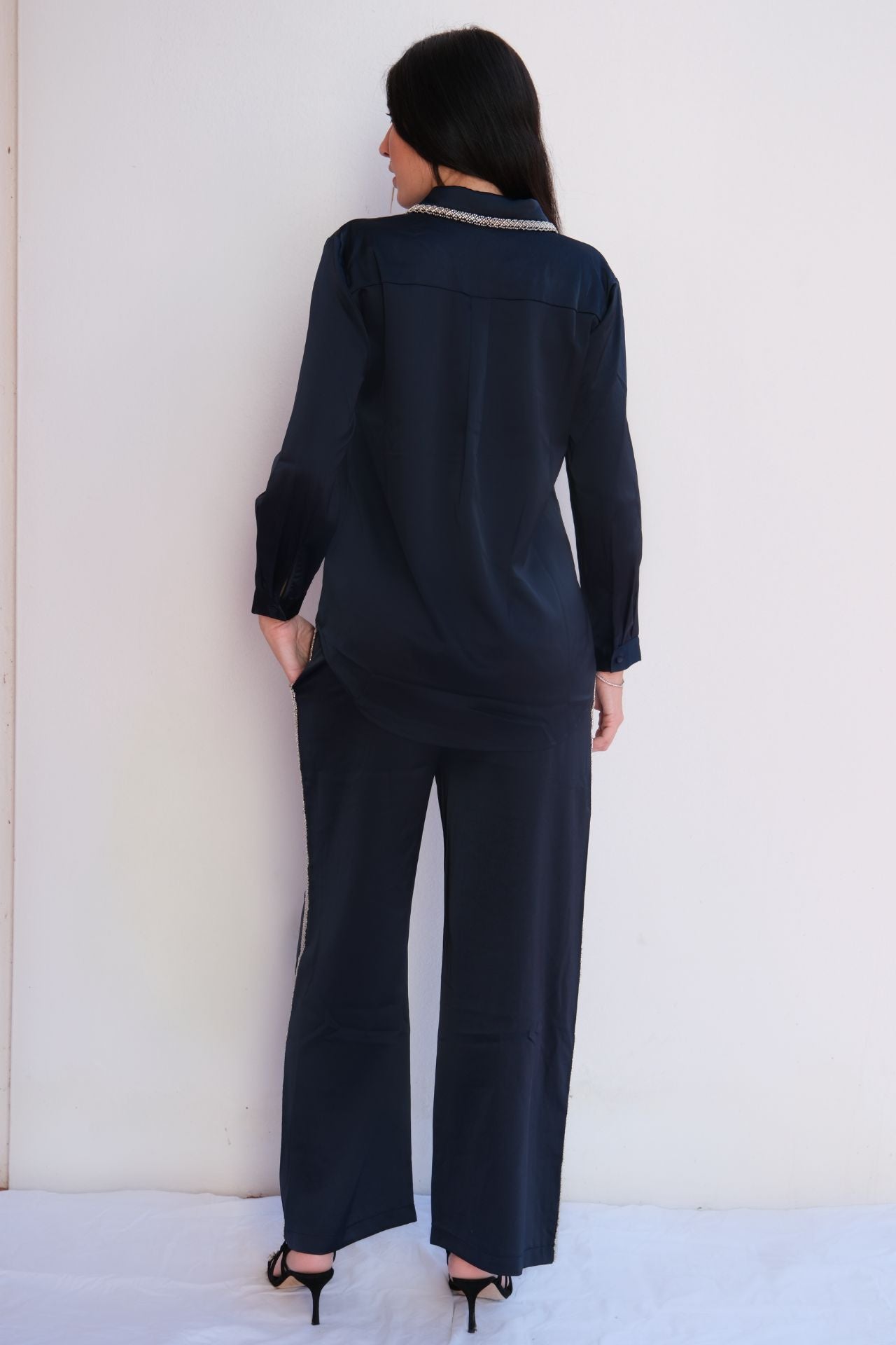 Navy two-piece set with crystal-embellished collar blouse and pull-on pants with side pockets, elegant everyday outfit for women back view.