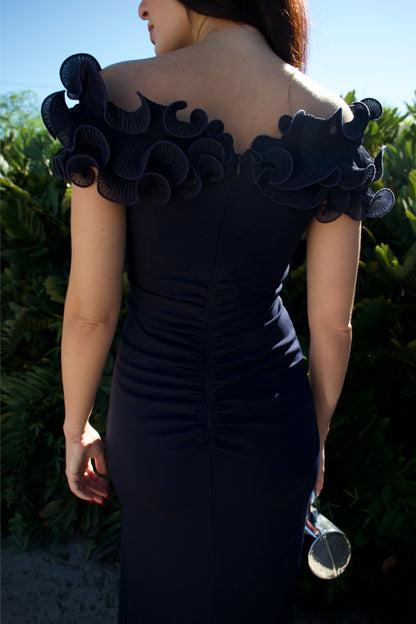 Model wearing navy evening gown with sculpted ruffle bodice and front slit — formal wear Elegance Boutique