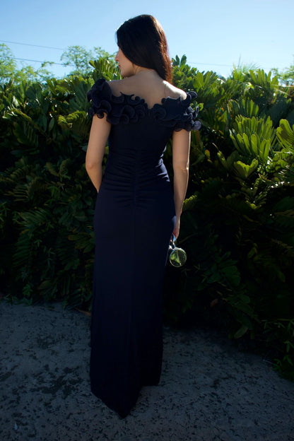 Model wearing navy evening gown with sculpted ruffle bodice and front slit — formal wear Elegance Boutique