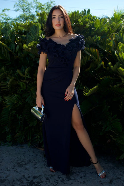 Model wearing navy evening gown with sculpted ruffle bodice and front slit — formal wear Elegance Boutique