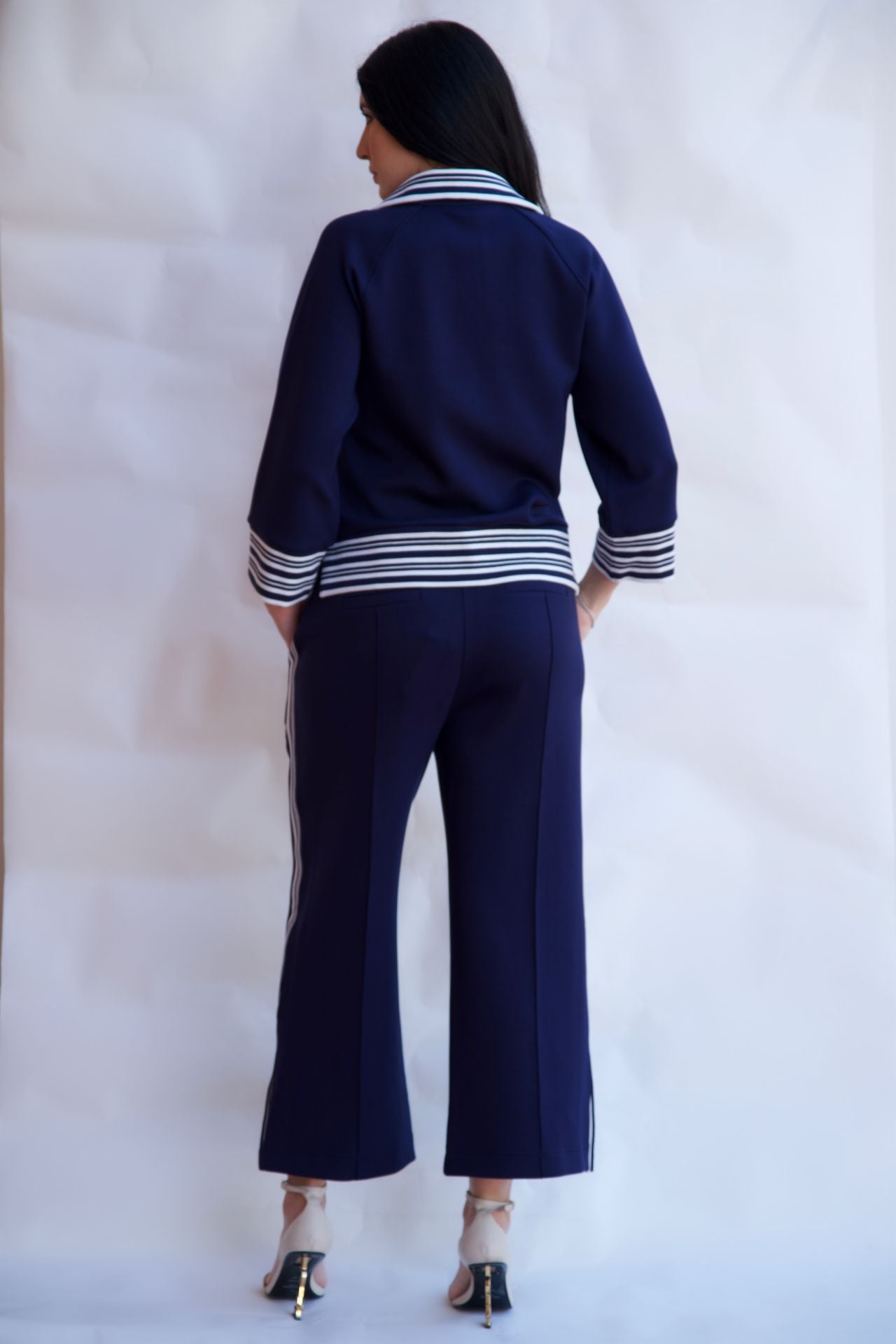 Navy striped zip up travel set with wide leg pants styled with heels available online and in-store