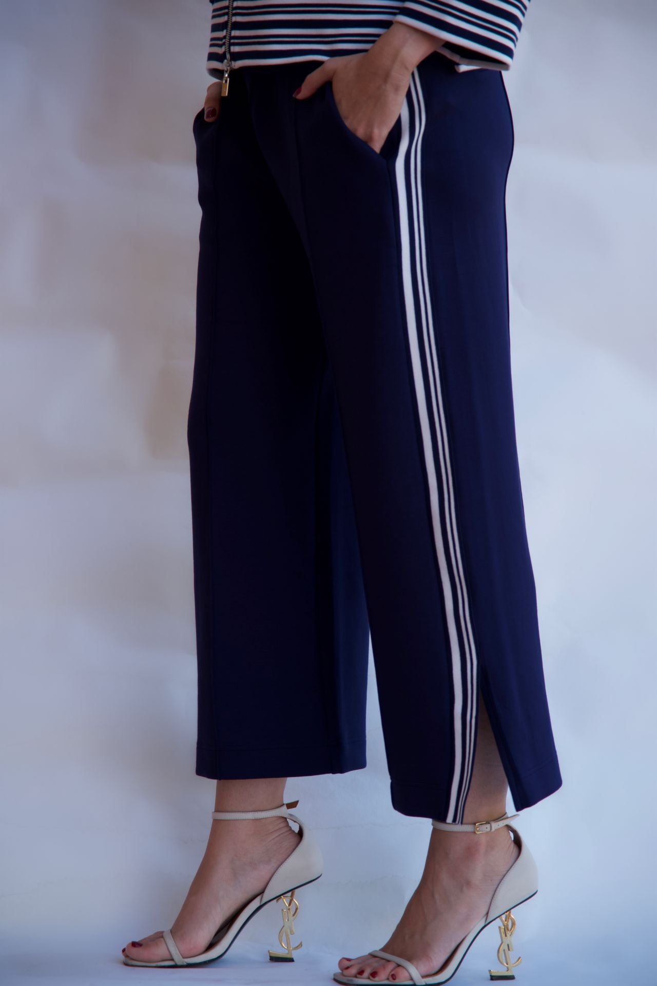 Navy striped wide leg pants styled with heels available online and in-store