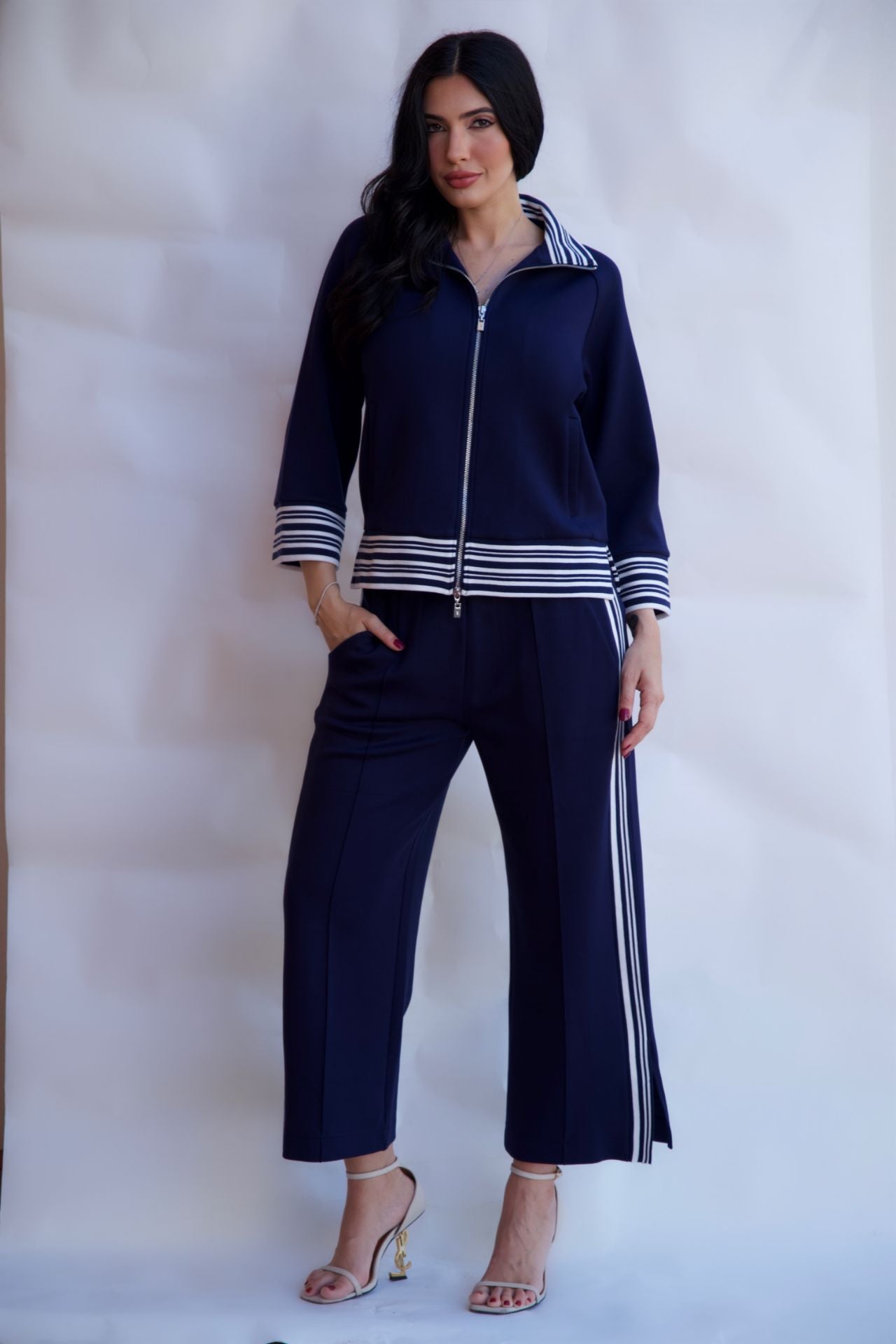 Navy striped zip up travel set with wide leg pants styled with heels available online and in-store