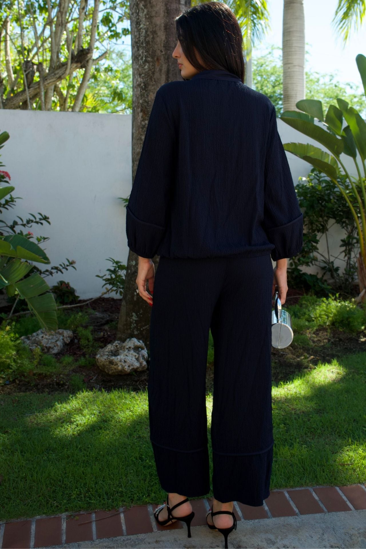 Navy textured zip jacket and barrel-leg pant set — relaxed modern two-piece outfit
