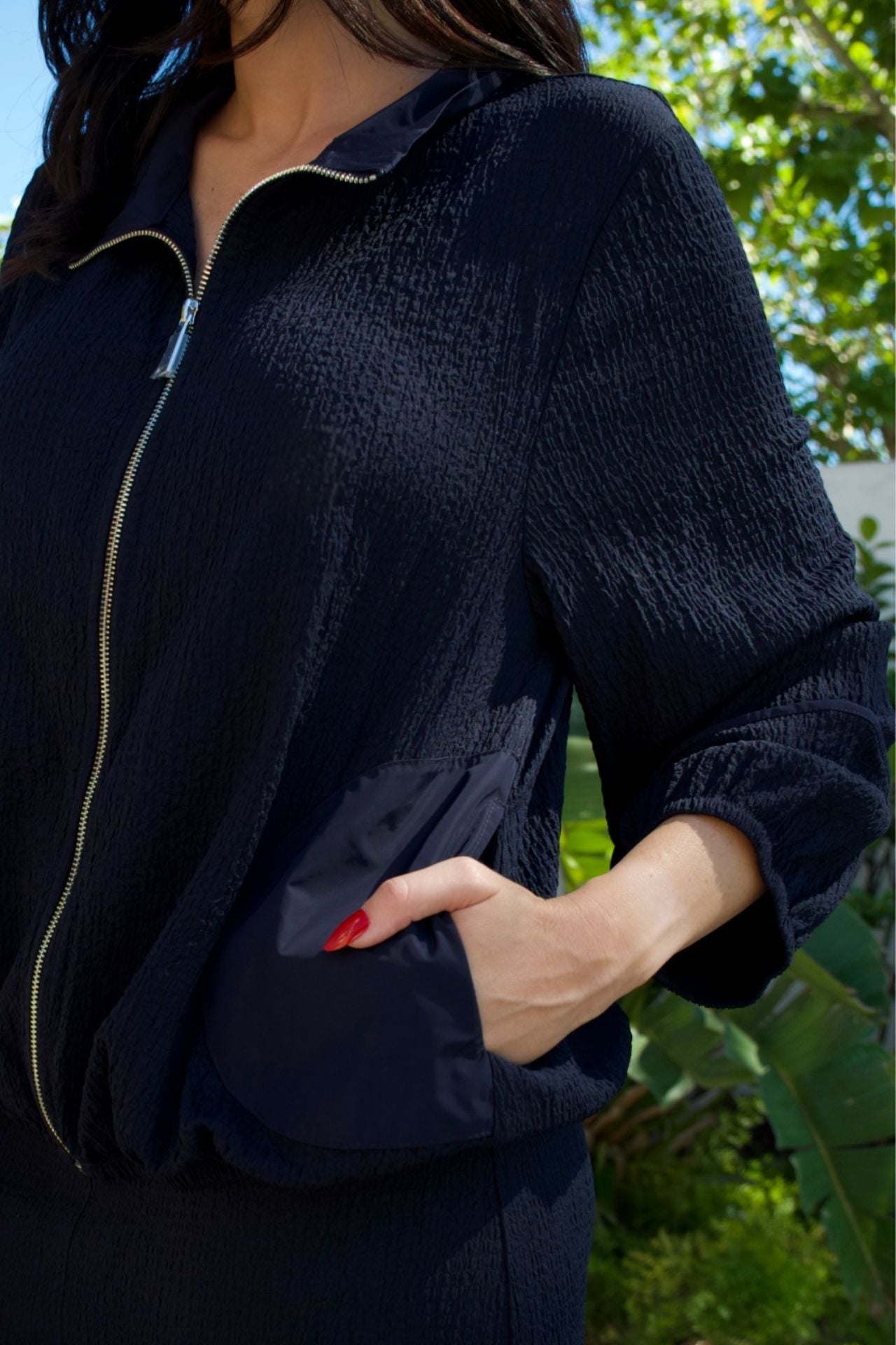 Navy textured zip jacket and barrel-leg pant set — relaxed modern two-piece outfit