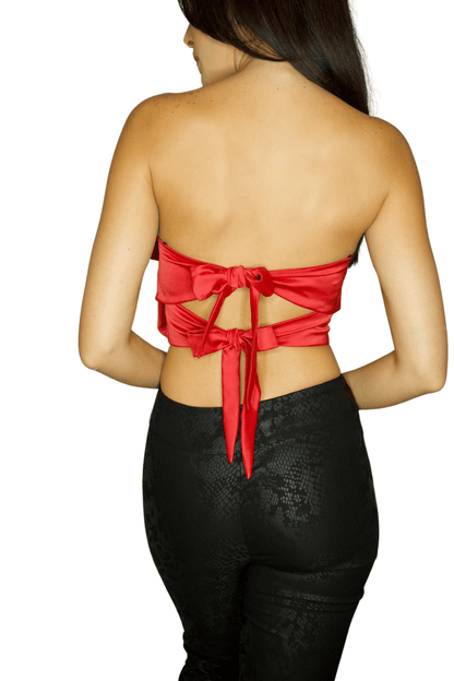 Back view of a woman wearing a red strapless top with a bow detail and a black pant