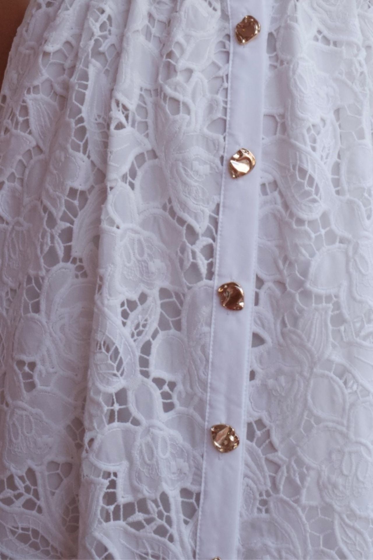 White lace maxi dress with belt and button front detail, elegant sleeveless occasion dress.