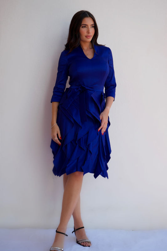 Royal blue taffeta dress with waist tie and ruffle skirt, styled for an elegant cocktail or special occasion look.