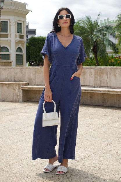Short sleeve blue mineral-wash jumpsuit.