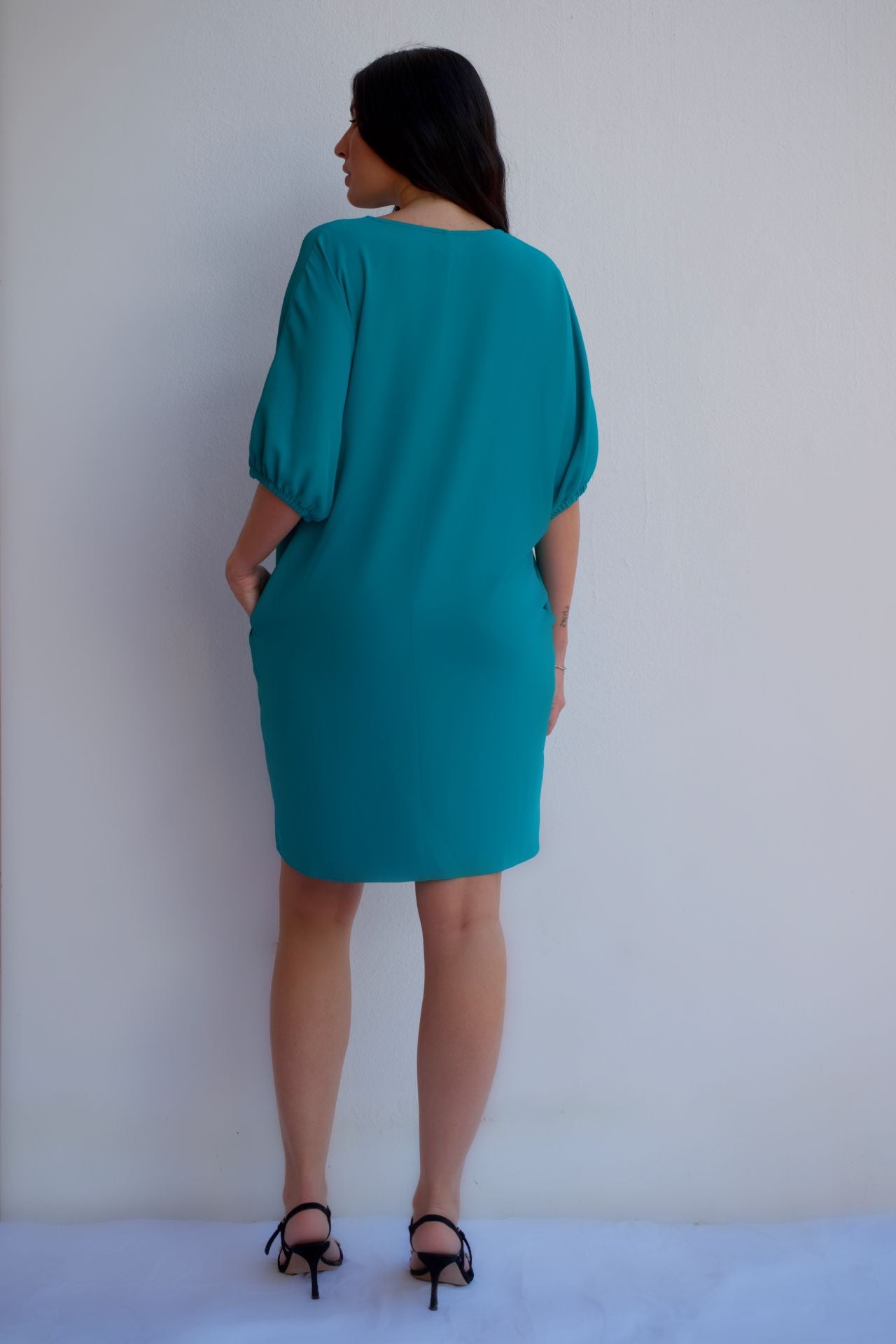 Back view turquoise relaxed fit zip dress with pockets, styled for an effortless day-to-night look.
