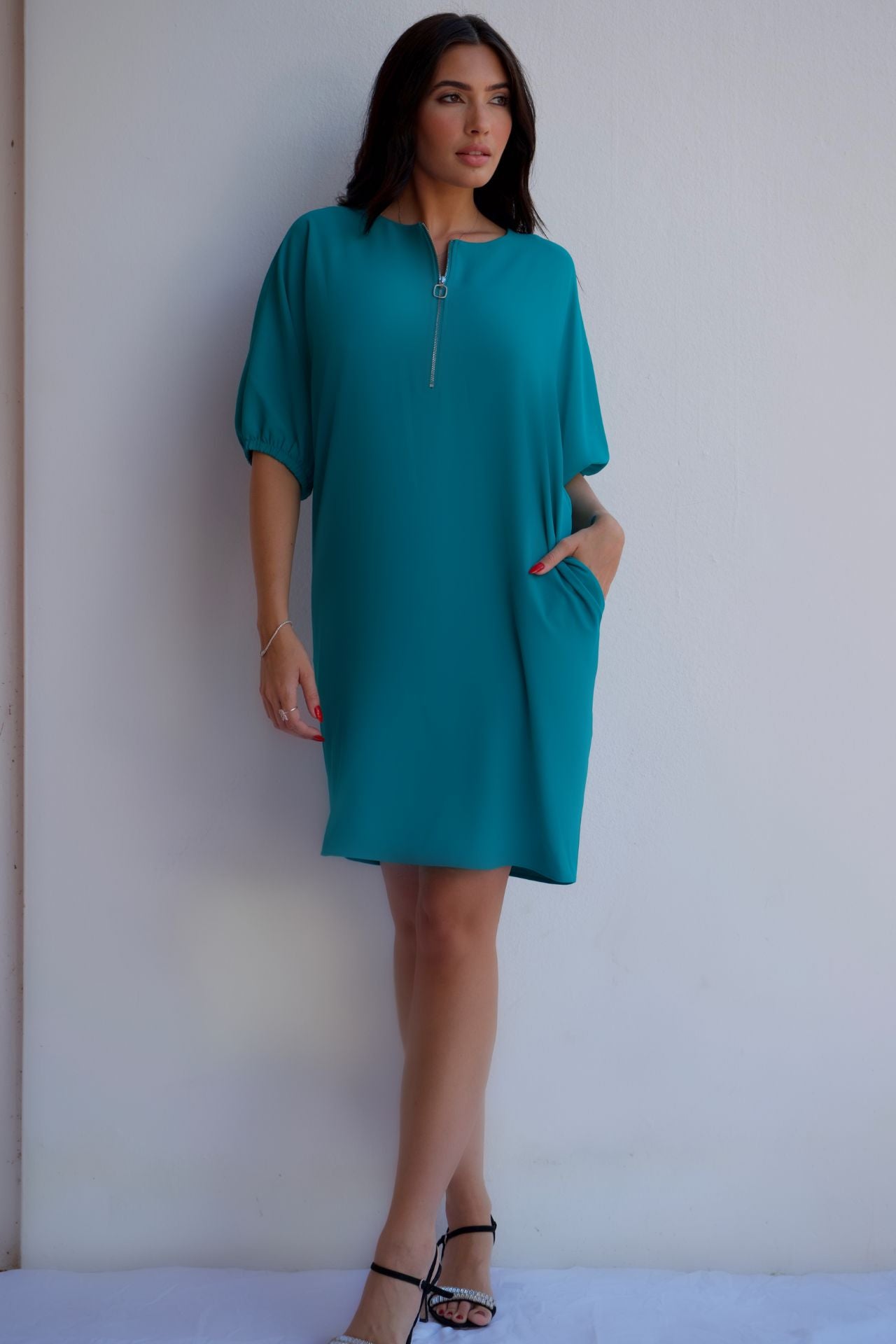 Turquoise relaxed fit zip dress with pockets, styled for an effortless day-to-night look.
