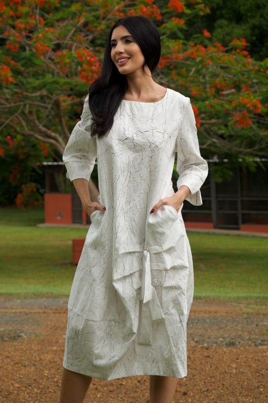 White and black textured modern dress – front view, sleeveless silhouette with gathered hem.