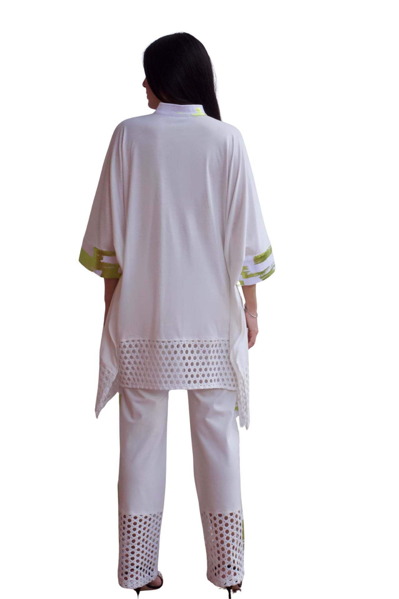 Woman wearing an elegant white eyelet detail pant set with relaxed high-low top and straight-leg pants.