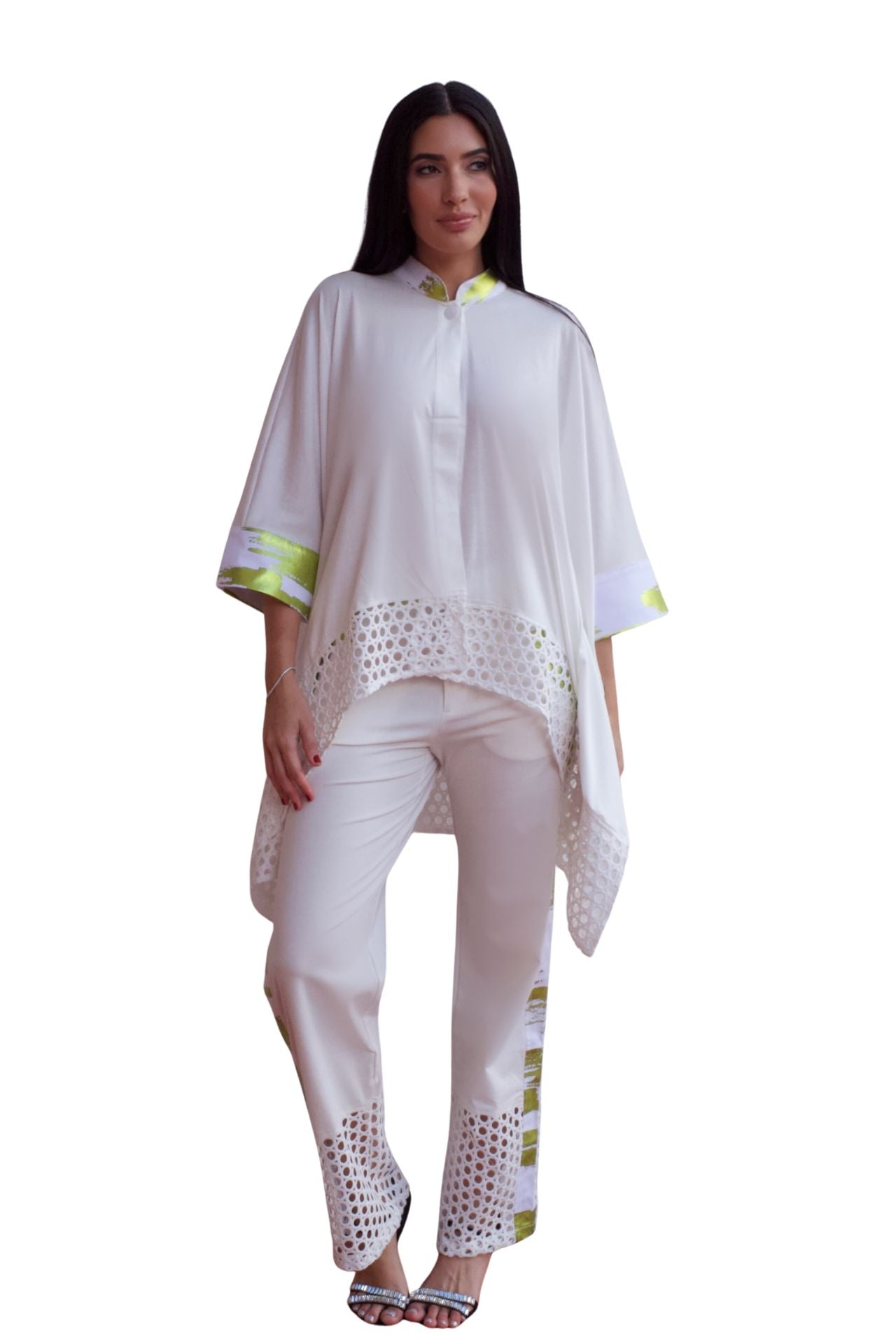 Woman wearing an elegant white eyelet detail pant set with relaxed high-low top and straight-leg pants.