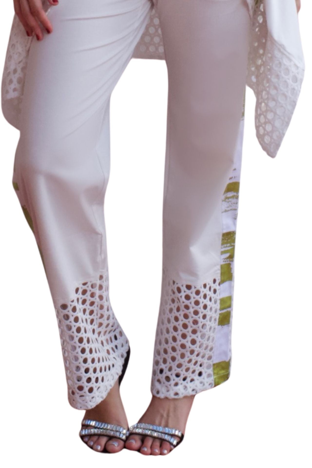 Woman wearing an elegant white eyelet detail pant set with relaxed high-low top and straight-leg pants.