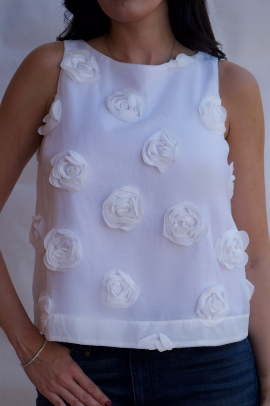 white rosette appliqué sleeveless textured blouse front view feminine statement top available online and in-store