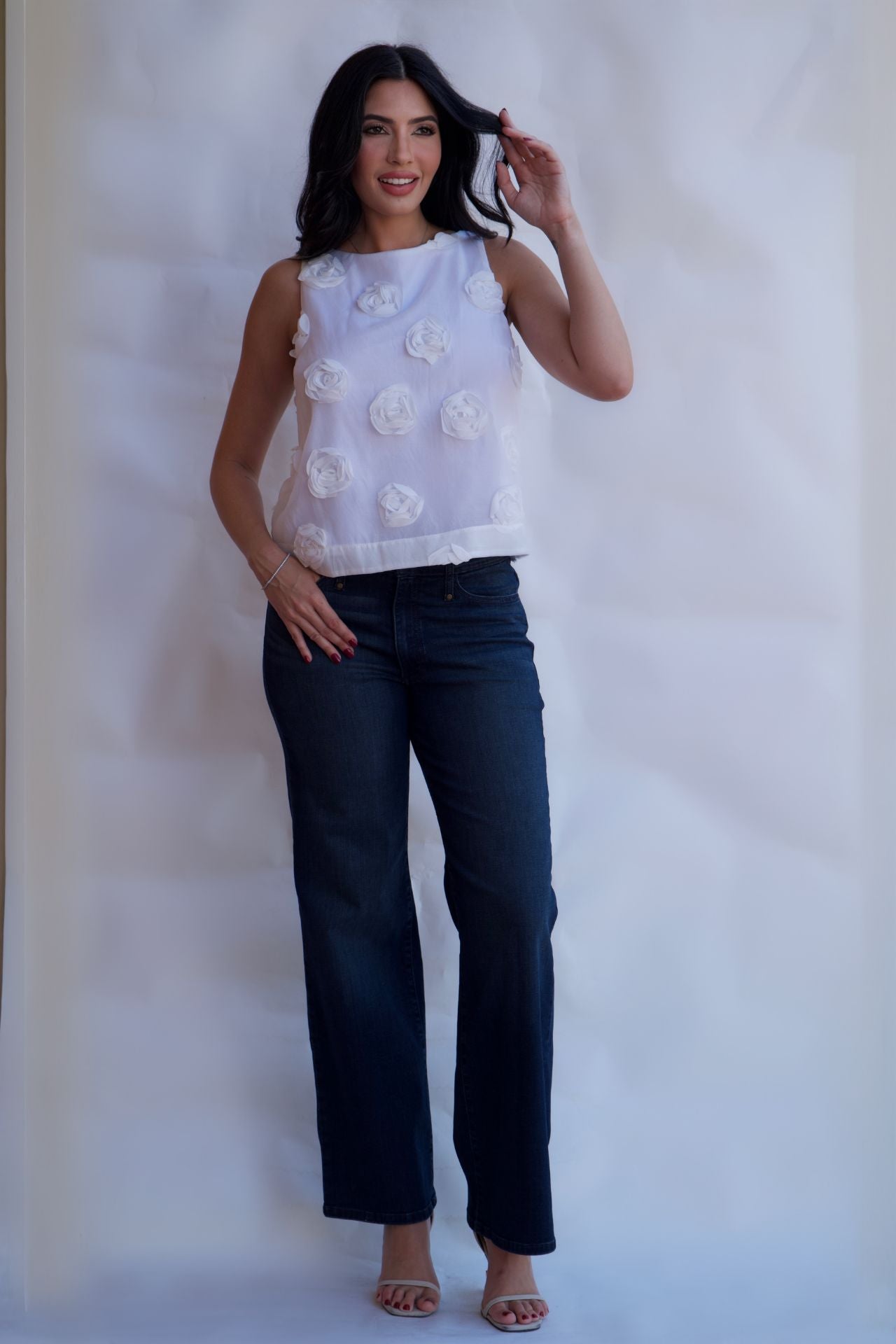 lifestyle look white rosette blouse styled with denim jeans chic spring outfit available online and in-store